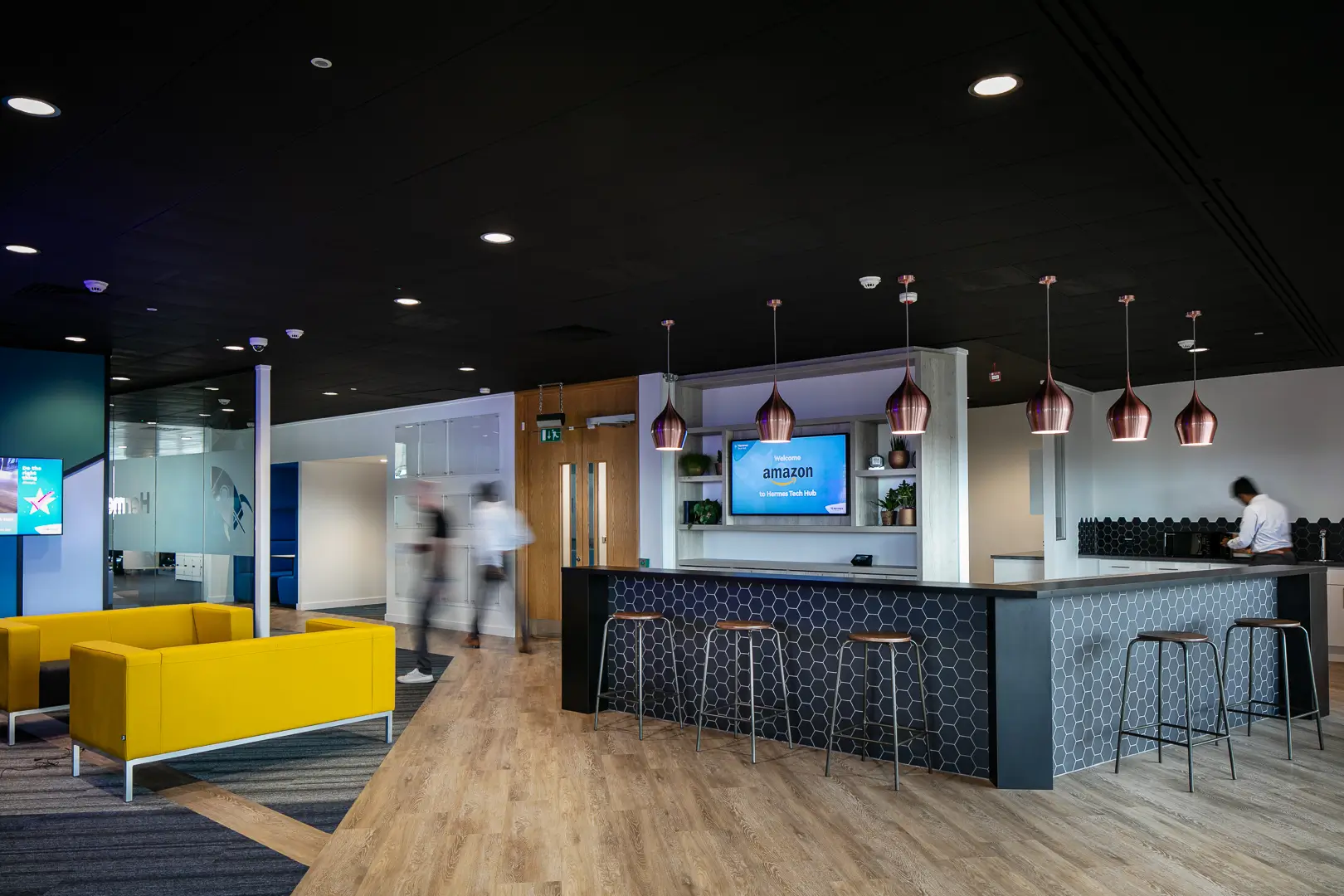 Evri tech hub social area with decorative pendants above a bar