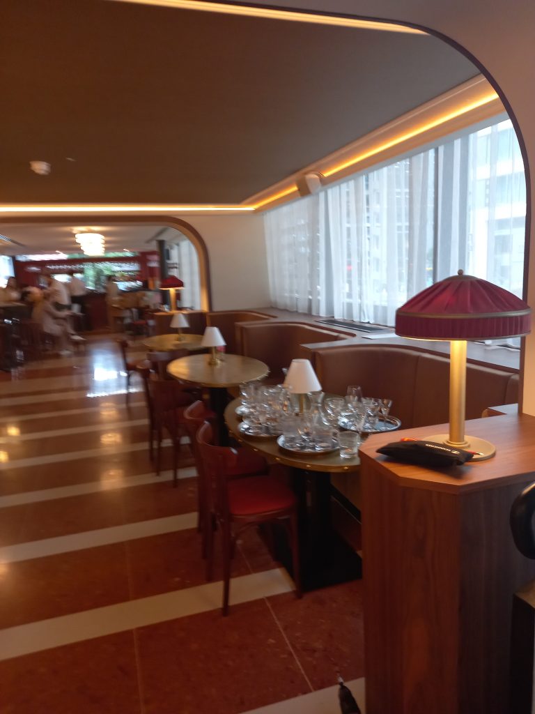 Bespoke red pleated table lamp with brass stem on a restaurant server station