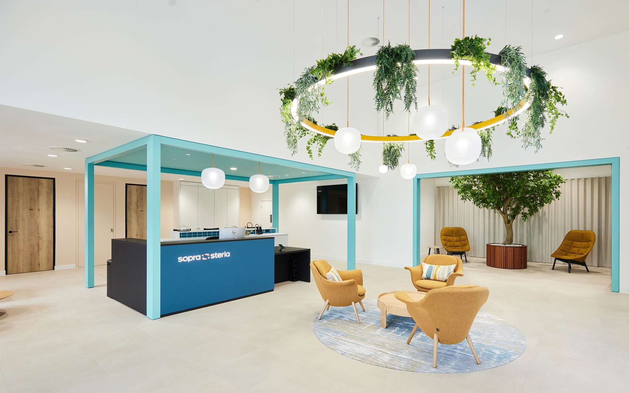 Sopra Steria reception with illuminated circular feature and globe pendants
